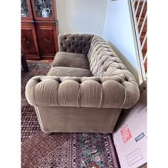 a couch sitting on top of a rug in a living room