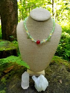 Hey sweet girl, this necklace is for you because you're berry sweet and warm like the summer. A juicy red strawberry glass charm playfully rests on the chest with this loose choker necklace. With spring green crackle glass beads (6mm), adorable yellow daisy beads, and green leaf beads, make up this unique necklace. On a stretch chord, the necklace measures 17 inches and is tied multiple times at the toggle to prevent breaking. Only 1 available, whoever grabs it is the sweetest. Cheap Green Round Charm Necklaces, Cheap Green Necklace With Flower Charm, Daisy Beads, Leaf Beads, Yellow Daisy, Yellow Daisies, Red Strawberry, Crackle Glass, Unique Necklace