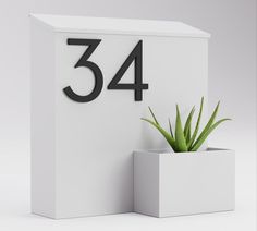 a white box with a plant in it and the number 34 on it's side