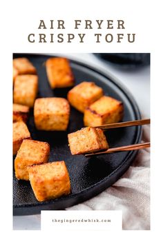 fried tofu on a black plate with chopsticks and text overlay reading air fryer crispy tofu