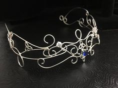 I wanted to create a magical and beautiful bohemian renaissance crown, also called a circlet, in all sterling silver, to which I've designed substantially to last a lifetime of enjoyment. Inspired by Lord of the Rings/Middle Earth with an Elvish Celtic feel, this headpiece can be worn not only for a bridal theme, but at any Renaissance event as well. This piece fits back towards the ears and has elastic fasteners to position in place for a secure and snug fit for your head shape. You will need t Bohemian Round Crown Headpiece For Wedding, Bohemian Wedding Headpiece With Round Crown, Handmade Elegant Festival Headpiece, Elegant Handmade Festival Headpiece, Bohemian Wedding Jewelry With Artistic Design, Elegant Silver Headpiece With Teardrop Crown, Elegant Silver Teardrop Crown Headpiece, Handmade Pinched Crown As A Gift, Adjustable Structured Crown Headpiece As Gift