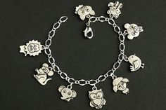 A collection of silver plated cartoon stylized baby animal themed charms have been dispersed around a shimmering silver plated bracelet chain in this handmade charm bracelet. This baby animals charm bracelet is then completed with a lobster clasp and a 1/2 inch of chain at the end for adjustable sizing. Charms in this bracelet include a lion charm, mouse charm, elephant charm, owl charm, lamb charm, bird charm, bear charm, fox charm, and pig charm. ● Sizing ● To determine your bracelet size, do Cute Nickel-free Charm Bracelet For Friendship, Playful Nickel-free Charm Bracelet For Gift, Playful Silver Charm Bracelet For Gift, Playful Silver Charm Bracelet As Gift, Playful Silver Charm Bracelet Perfect As A Gift, Playful Silver Jewelry For Friendship, Silver Novelty Charm Bracelet For Birthday, Nickel-free Silver Novelty Charms, Personalized Playful Silver Charm Bracelet