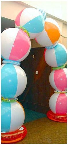 several beach balls are stacked on top of each other in the shape of a arch