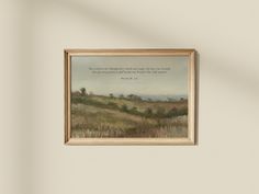 a painting hanging on the wall with a bible verse written in it's center