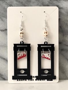 Step into the spooky season with these Handmade Halloween Earrings! Each pair is meticulously crafted with attention to detail, featuring an array of Macabre, Gothic, and Halloween designs. From skulls and skeletons to spiders and spider webs, these earrings showcase a range of eerie elements like ghosts, coffins, crosses, witch hats, and even guillotines. Perfect for expressing your Halloween spirit or adding a touch of everyday Gothic aesthetic, these earrings are sure to make a statement. Mad Edgy Adjustable Earrings For Halloween, Edgy Pierced Halloween Earrings, Edgy Halloween Pierced Earrings, Edgy Pierced Earrings For Halloween, Edgy Halloween Drop Earrings, Edgy Drop Earrings For Halloween, Edgy Handmade Halloween Earrings, Edgy Handmade Earrings For Halloween, Edgy Dangle Earrings For Halloween