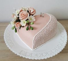 a heart shaped cake with flowers on top