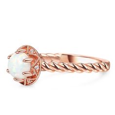 Embrace the beauty of this rose gold engagement ring, a testament to your enduring love story. Crafted in sterling silver, this stunning piece features a dazzling white opal as its centerpiece, radiating with a captivating brilliance. The intertwining design of the ring's band represents the unbreakable bond between two souls, forever entwined in a journey of love and commitment. Each twist and turn signifies the twists and turns of life, reminding us that love can weather any storm and emerge even stronger. With its delicate rose gold hue, this ring embodies elegance and sophistication, making it the perfect choice for a love that knows no bounds. The opulent white opal, with its ethereal charm, serves as a reminder of the enchanting moments shared and the dreams yet to be fulfilled.Carat Opal Engagement Ring Twisted Band, Elegant Opal Ring With Center Stone, Elegant Adjustable Opal Ring For Anniversary, Elegant Opal Promise Ring, Elegant Opal Birthstone Ring For Anniversary, Elegant Opal Rings With Halo Design, Adjustable Elegant Opal Promise Ring, Rose Gold Promise Opal Ring, Elegant Opal Promise Ring With Birthstone