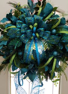 a blue and green wreath hanging on the front door