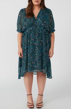 A dainty floral print adorns this dress crafted with elbow-length sleeves and an asymmetric, tiered ruffle hem. 42 1/2" length (size 16) Hidden back-zip closure V-neck Short sleeves Partially lined 100% polyester Machine wash, dry flat Imported Blue Floral Print Tiered Dress, Blue Floral Print Tiered Skirt Dress, Blue Floral Print Dress With Tiered Skirt, Blue Layered Hem Dress For Spring, Blue Short Sleeve Tiered Dress With Ruffle Hem, Blue Dresses With Layered Hem For Spring, Blue Floral Print Midi Dress With 3/4 Sleeve, Blue Short Sleeve Tiered Dress For Spring, Blue 3/4 Sleeve Dress With Ruffles