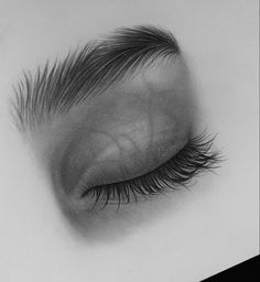 an eye with long lashes is shown in black and white