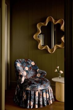 a chair and mirror in a room with wood paneling