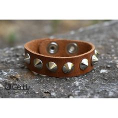 Handcrafted leather bracelet with one row of short metal spikes. You can adjust the length, as it comes with two different buttons. Width 18mm. Length 23cm. Minimum wrist measurement 19cm. We suggest you measure your wrist and give us the measurement before shipping. Trendy Adjustable Spiked Bracelets, Silver Leather Bracelet With Spikes, Silver Leather Bracelets With Spikes, Trendy Jewelry With Rivets For Gifts, Trendy Jewelry With Rivets As Gift, Edgy Adjustable Bracelets With Studs, Trendy Adjustable Bracelets With Rivets, Adjustable Silver Bracelet With Spikes, Adjustable Leather Bracelet With Spikes