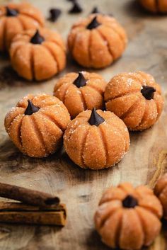 small pumpkins with chocolate chips on a wooden table next to cinnamon sticks and spices