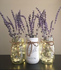 three mason jars with lavender flowers in them