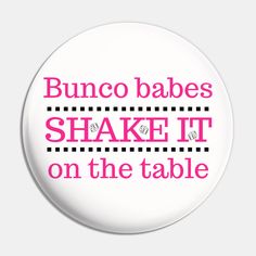 a button with the words bunco babes shake it on the table in pink