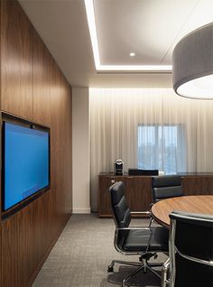 an empty conference room with a flat screen tv