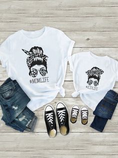 Embrace Mommy & Me fashion with this stylish printed graphic tee. Simple but fab, this round-neck shirt is decorated with cool artwork and #MOMLIFE or #KIDLIFE text. Guaranteed to make you and your mini-me look like twinning off-duty supermodels! Lightweight, high-quality fabric ensures you are comfortable, so you and your little one can look confident and stylish throughout the day. Graphic artwork and text details make a fashion statement. Guaranteed to get you and your precious ones unlimited compliments! Perfect for family events, photoshoots, casual outings, and year-round events Round neck tee with "#MONLIFE" or "#KIDLIFE"" graphic print Tops only available in sizes 6MON-24MON, 3T-8Y for toddlers and girls; S-3XL for mom Mom and girls' sizes are sold separately Family Matching White T-shirt With Cartoon Print, Trendy Unisex T-shirt With Letter Print, Trendy Printed Crew Neck T-shirt, Casual Comfortable Fit T-shirt With Letter Print, Comfortable Fit Graphic Print T-shirt For Summer, Comfortable Summer T-shirt With Graphic Print, Cool White T-shirt With Funny Print, Casual Tops With White Funny Print, Family Matching Cartoon Print Cotton Tops