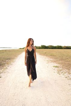 Our stylish, must-have version of the essential LBD (little ​beach dress), the Sage Maxi Dress Black is a flowing asymmetric dream that’s perfect for mid-summer events, beach days, and travel. The silhouette is inspired by the tranquil vibes of Tulum’s beaches and bustling energy of its town center. It features long straps you can wrap twice around the waist for an adjustable fit. Breathable fibers keep you cool as you lounge, explore, and indulge all summer long. - V-neckline- Adjustable straps Black Summer Midi Dress For Beach Season, Black Summer Midi Dress For Beach, Black Midi Beachwear Dress For Summer, Black Beachwear Midi Dress For Vacation, Black Summer Midi Dress For Vacation, Black Midi Dress For Summer Beach Outing, Black Flowy Chic Beach Dress, Black Sundress Midi Dress For The Beach, Black Midi Dress For Summer Beach