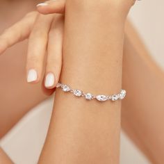 a woman's arm wearing a diamond bracelet