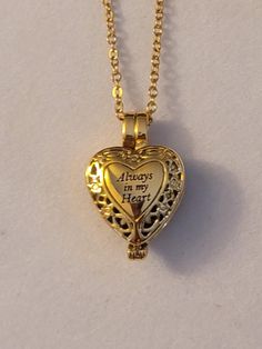 Gold Heart Cremation Urn Necklace.  Heart says, Always In My Heart.  Comes with everything needed to help you get the ashes into the urn at no additional charge.  ** We also carry this necklace in silver. Comes on a 20 inch gold stainless steel chain.  Please feel free to message us with any questions you may have.  Thank you so much. Gold Heart Locket Necklace Spiritual Style, Gold Heart-shaped Spiritual Locket Necklace, Spiritual Gold Heart Locket Necklace, Keepsake Open Heart Necklace With Heart Beads, Heart Beads Necklace For Keepsake, Adjustable Heart Keepsake Necklace, Adjustable Heart Necklace For Keepsake, Adjustable Heart-shaped Keepsake Necklace, Personalized Heart Shaped Spiritual Necklace