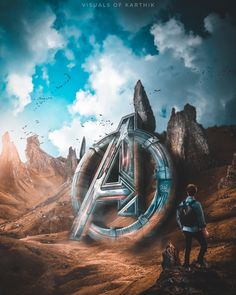 a man standing on top of a mountain next to a giant letter in the sky