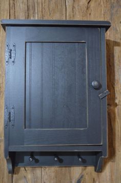 an old fashioned black stove with knobs on the front and back sides, sitting on a wooden floor