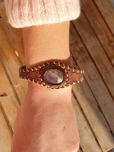 Brown Leather Bracelet With Amethyst Gemstone, Handcrafted Unisex Leather Bracelet, Ametshyst Stone, Handcrafted Bracelet With Gemstone This gemstone bracelet has been hand made carefully for you. The Amethyst stone was used in making the bracelet. With its adjustable cord, you can use it as S (16.5cm(6.5 inch)) M (18cm(7inch)) L (19.5cm (7.6inch)). Special techniques have been used to shape the leather. this gemstone is unique in shape and texture. Note: Please contact us for different stone op Handmade Amethyst Beaded Bracelets In Bohemian Style, Bohemian Amethyst Beaded Bracelets Handmade, Handmade Amethyst Cuff Bangle Bracelet, Natural Stones Leather Bracelet Gift, Unique Adjustable Amethyst Bracelets, Unique Handmade Amethyst Bracelets, Artisan Purple Bracelet Jewelry, Adjustable Purple Bohemian Cuff Bracelet, Handmade Amethyst Festival Jewelry