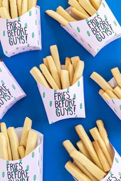 french fries are sitting in paper containers on a blue surface with the words fries before guys written on them