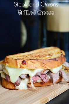 steak and onions grilled cheese sandwich on a cutting board