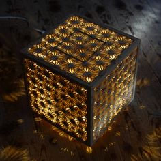 a lit up cube sitting on top of a wooden floor