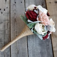 a bridal bouquet with flowers on a wooden surface