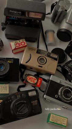 many different types of cameras on a table