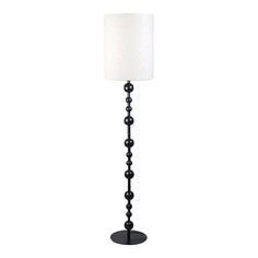 a floor lamp with a white shade on it's side and black bead trim around the base