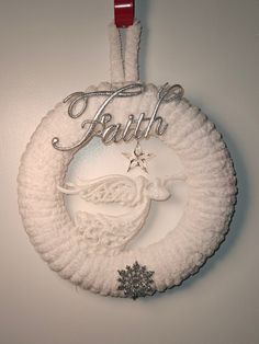 a white christmas ornament hanging on a wall