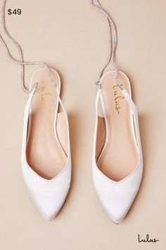 You can strut down the aisle or dance the night away in effortless style and comfort, thanks to the Lulus Finnian White Satin Rhinestone Lace-Up Pointed-Toe Flats! Luxe woven satin shapes these diva-approved flats that feature a classic pointed-toe upper and a low-cut collar that continues into long, rhinestone-embellished laces that wrap and tie above the ankle. 0. 25" rubber heel. Lightly cushioned insole. Felted rubber sole has nonskid markings. Man made materials. Imported. Lulus | Finnian White Satin Rhinestone Lace-Up Pointed-Toe Flats. Wedding Shoes Flats For Bride, Wedding Shoes Bride Flats, Flat Shoes For Wedding, Flat Wedding Shoes For Bride, Wedding Flats For Bride, Bride Flats, Flat Wedding Shoes, Winter Wedding Shoes, Bridal Flats