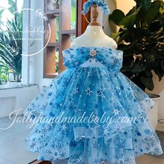 ♥ Introducing our enchanting blue dress adorned with delicate floral patterns, designed specifically for little girls who dream of embodying the elegance of their favorite princess, Elsa from Frozen. This exquisite dress features a captivating combination of blue, pink, and white hues, creating a magical appearance that is sure to delight any young girl. ♥ The sleeveless design is complemented by a unique style on the chest, while a large, eye-catching bow at the back adds a touch of charm and s Blue Floral Applique Dress For Dress-up, Blue Tulle Dress For Party, Blue Tulle Party Dress, Whimsical Blue Dress For Dress-up, Cute Blue Fairy Dress For Summer, Light Blue Tulle Dress With Floral Applique, Blue Floral Applique Wedding Dress, Blue Wedding Dress With Floral Applique, Blue Princess Fairy Dress For Party