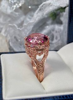 Natural Pink Topaz Ring Princess Design#29 Custom Made Inspired by Georgian and Victorian era filigree designs, I now offer this stunning reproduction in sterling silver with rose gold overlay. This fabulous ring is set with a 7.4ct VVS natural genuine pink topaz gemstone. The round full cut high quality gemstone is 13mm (1/2th of an inch) in diameter. The gemstone has excellent color and clarity. The inside of the band is marked 925 for sterling. Notice the beautiful intricate leaf prongs and f Fine Jewelry Rose Gold Topaz Ring With Accent Stones, Rose Gold Topaz Ring Fine Jewelry, Rose Gold Topaz Ring With Accent Stones, Elegant Rose Gold Topaz Birthstone Ring, Rose Gold Round Topaz Birthstone Ring, Rose Gold Topaz Ring With Accent Stones For Gift, Rose Gold Topaz Ring With Birthstone, Rose Gold Topaz Ring For Gift, Rose Gold Topaz Ring