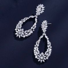 Bold and beautiful, this pair of bridal earrings will add a touch of sophistication to any wedding gown or formal ensemble. Adorned with flawlessly faceted cubic zirconia that capture the light in a dazzling array of sparkles, the earrings are rhodium/rose gold plated for a bright finish which enhances the intricate detailing and conveys a modern take on old elegance. Length: 2.5" (approx. 6.3cm). Width: 1" (approx. 2.5cm). Weight: 10g. Available in Silver and Rose Gold finishes. To make your ch Bridal Earrings Silver, Cubic Zirconia Bridal Earrings, Silver Bridal Earrings, Sleek Updo, Soft Waves, Bold And Beautiful, Wedding Trends, Earrings Silver, Bridal Earrings