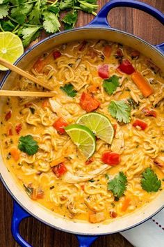 a blue pot filled with soup and garnished with cilantro