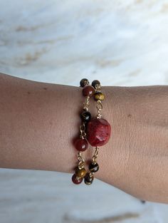 Unleash the power of nature with our stunning red jasper and tiger's eye bracelet, intricately crafted with a handmade chain. Red jasper is known for its grounding properties, promoting stability and endurance, while tiger's eye enhances courage and strength. Each bracelet is a one-of-a-kind creation, brimming with the potent energy of these remarkable stones. Embrace the unique power of this bracelet and embark on your journey with confidence and resilience. https://www.etsy.com/listing/1718274 Adjustable Brown Carnelian Bracelets, Adjustable Spiritual Garnet Jewelry, Handmade Carnelian Amber Bracelets, Red Agate Jewelry With Natural Stones, Red Natural Stones Jewelry For Healing, Red Agate Bracelets With Gemstone Beads, Red Carnelian Bohemian Bracelets, Adjustable Garnet Gemstone Bracelets, Adjustable Garnet Gemstone Bracelet