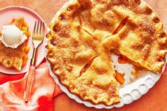 an apple pie on a plate with a fork next to it