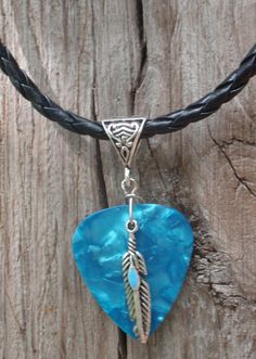 a necklace with a blue heart and an arrow on it