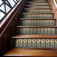 the stairs are decorated with decorative tiles and wooden handrails as well as wood flooring