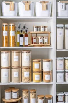 an organized pantry filled with lots of different types of spices and food items on shelves