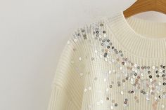 Relaxed Fit 51% Acrylic. 39% Nylon. 7% and 3% Elastane Dry Clean Only Crew Neckline Long Sleeves Sequin Detailing Soft. Knit Fabrication No Closures Not lined Look oh so festive in the Too Cool Sequin Knit Sweater! This cream knit sweater sparkles with orange. hunter green. gold. pink. silver. and yellow sequins across the front. The crew neckline and ribbed edges add just the right touch of detail. Rock your holiday luncheon look by pairing this fun sweater with light wash denim. Styled with the Showstopper Earrings and Sofia Distressed High Rise Denim. One size; Chest 92CM Should 48CM Sleeve Length 43CM Length 57CM