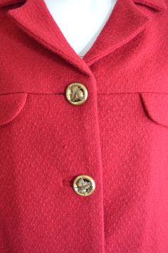 "Here is a classic 1960s skirt suit. Very Jackie Kennedy. Short jacket that hits at the waist with a matching straight skirt. Buttons up the front with pretty brass buttons and bound buttonholes. Fully lined in matching red. Skirt zips up side with a metal zipper and finishes with a hook and eye. perfect with a pair of Herbert & Beth Levine stilettos in black alligator. Label: none Condition: excellent. no flaws Measurements: JACKET Bust: 42\" Waist: 39\" Length: 18\" SKIRT Waist: 27\" Hip: Classic Notch Lapel Skirt Suit With Buttons, Classic Skirt Suit With Notch Lapel, Vintage Skirt Suit With Buttons For Office, Vintage Office Skirt Suit With Buttons, Classic Winter Skirt Suit With Button Closure, Classic Winter Skirt Suit With Buttons, Winter Classic Skirt Suit With Button Closure, Retro Formal Skirt Suit With Buttons, Vintage Skirt Suit With Button Closure For Formal Occasions