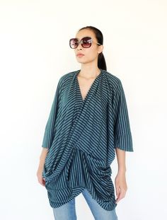 "🚚..ALL ORDERS ARE SHIPPED VIA DHL EXPRESS MAIL Refine your casual look with the luxurious of a beautifully feminine look. * Pull-on style * V neckline * Dropped shoulder; short sleeves * Drape front * An asymmetrical hem * Allover stripes pattern Measurements approximately: Shoulder: 40\" (101.5 cm)-shoulder to shoulder Bust: 64\" (162 cm) Sleeve length: 4\" (10 cm) Sleeve cuff: 14\" (35.5 cm)-round Hips: 44\" (112 cm) Top length from shoulder to hem: 25\" (63.5 cm) at centre front and 31\" (7 Drapey Asymmetrical Summer Tops, Asymmetrical Viscose Top For Summer, Summer Asymmetrical Viscose Top, Chic Viscose Tops With Asymmetrical Hem, Fitted Asymmetrical Blouse For Daywear, Chic Viscose Top With Asymmetrical Hem, Versatile Draped Summer Top, Asymmetrical Viscose Top For Spring, Asymmetrical Hem Blouse For Spring Daywear