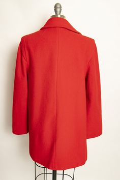 "Vintage 1980s coat of bright red warm wool. Long sleeves with button belt band cuffs. Collared, buttons up front. sleek silhouette flares out a bit. Side hip pockets. Built in padding at shoulders. Fully lined in red satin Label: Fashionfila Fits like size: Small Measurements: Bust: 36\" Waist: 38\" Length: 29\" Shoulder to shoulder: 17\" Sleeve length: 23\" Condition: Excellent. Please do not hesitate to convo with any questions. We upload large pictures - Simply click on each picture for a cl Red Double-breasted Wool Outerwear, Classic Red Wool Coat, Red Wool Double-breasted Outerwear, Classic Red Long Wool Coat, Red Wool Long Pea Coat, Red Wool Outerwear With Button Closure, Red Wool Coat For Spring Workwear, Red Wool Outerwear For Spring, Red Single-breasted Wool Coat For Fall