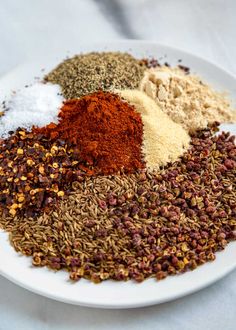 a white plate topped with different types of spices