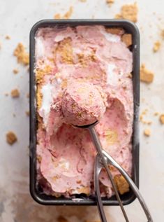 a scoop of ice cream in a black container